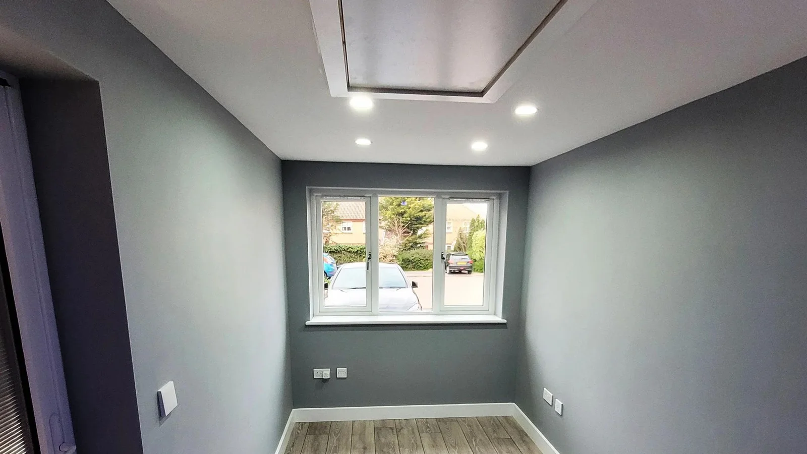 Completed ASUKA247 garage conversion interior with flooring, lighting and finished walls